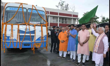 The chief minister of Haryana rides a state-owned bus and converses with the patrons.