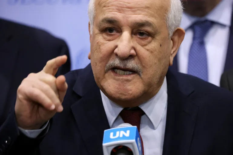 Palestinian Ambassador to the UN Riyad Mansour speaks with the media after a meeting of the Security Council to vote on a resolution demanding an immediate ceasefire in the Gaza Strip 