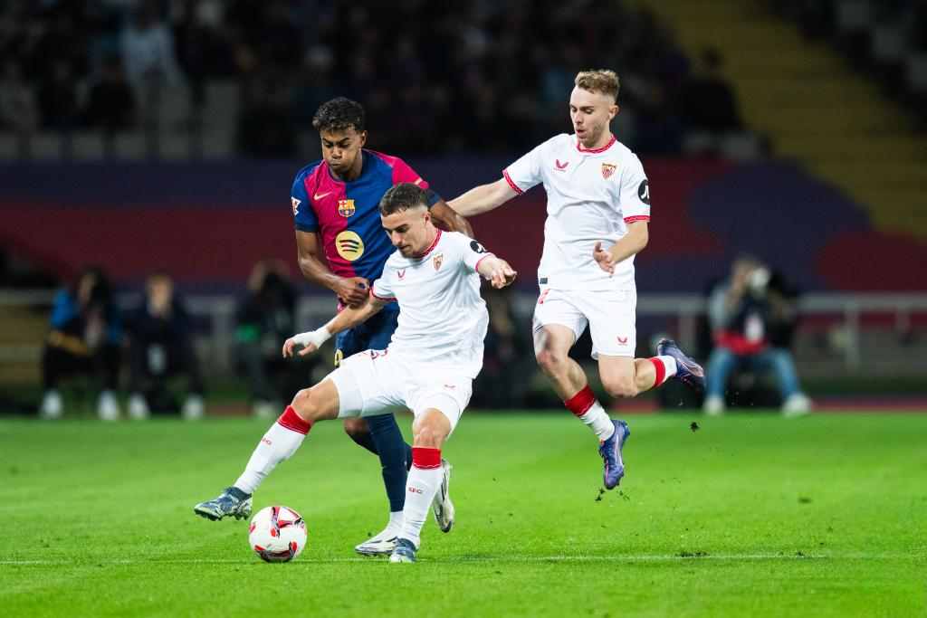 Lamine Yamal (L) of FC Barcelona vies with Adria Pedrosa (C) and Peque of Sevilla FC during the La Liga football match between FC Barcelona and Sevilla FC in Barcelona, Spain, on Oct. 20, 2024