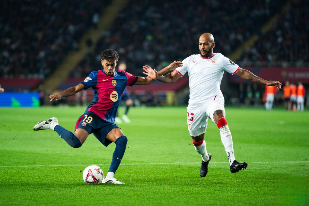 Lamine Yamal (L) of FC Barcelona vies with Marcao of Sevilla FC during the La Liga football match between FC Barcelona and Sevilla FC in Barcelona, Spain, on Oct. 20, 2024