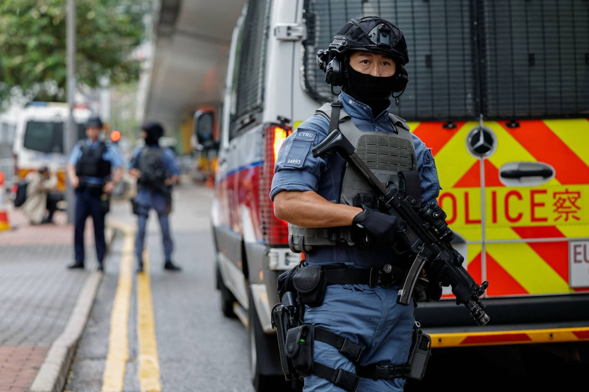 Police stand guard outside the West Kowloon Magistrates' Courts building, before the sentencing against the 45 convicted pro-democracy activists charged under the national security law, in Hong Kong, China November 19, 2024.