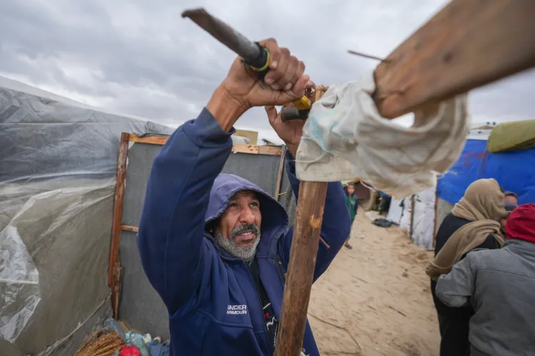 A Palestinian men fixing his house.