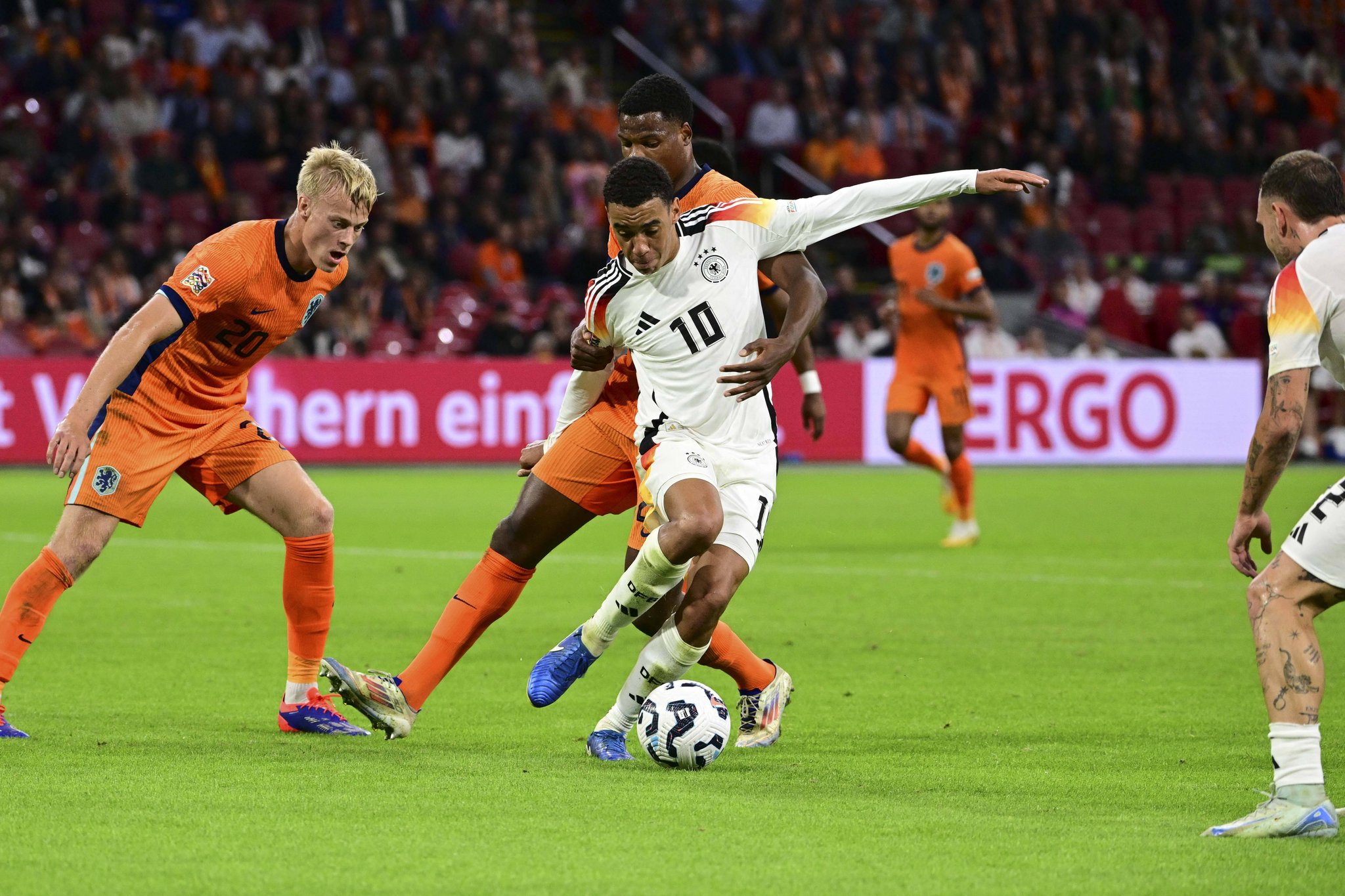 Soccer Football - Nations League - League A - Group 3 - Netherlands v Germany - Johan Cruyff Arena, Amsterdam, Netherlands - September 10, 2024 Netherlands' Denzel Dumfries celebrates scoring their second goal with teammates