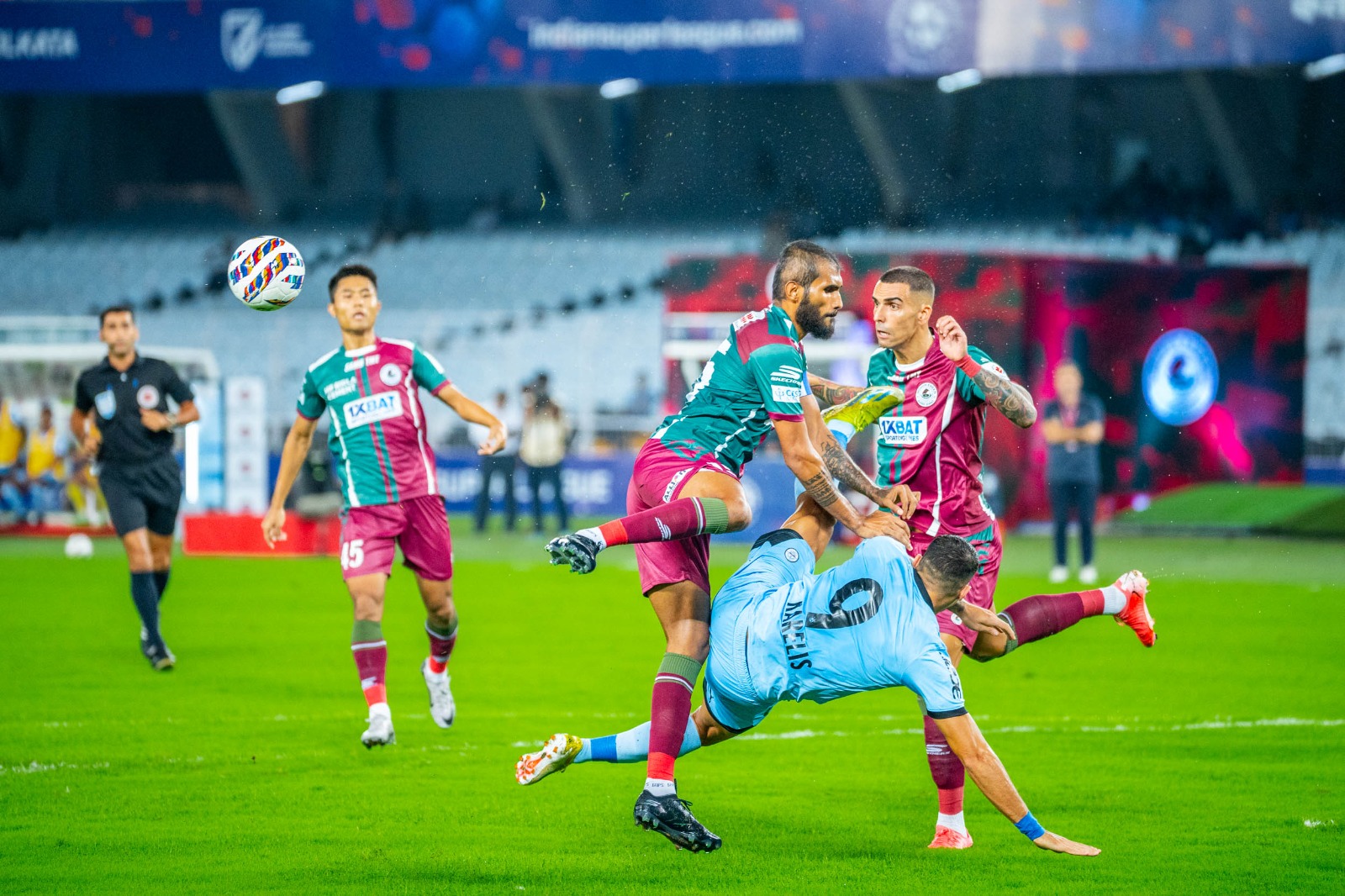 Mumbai City defender Tiri (extreme left) scores an own goal to give Mohun Bagan Super Giant a 1-0 lead during the ISL-XI opener at the Salt Lake Stadium on Friday