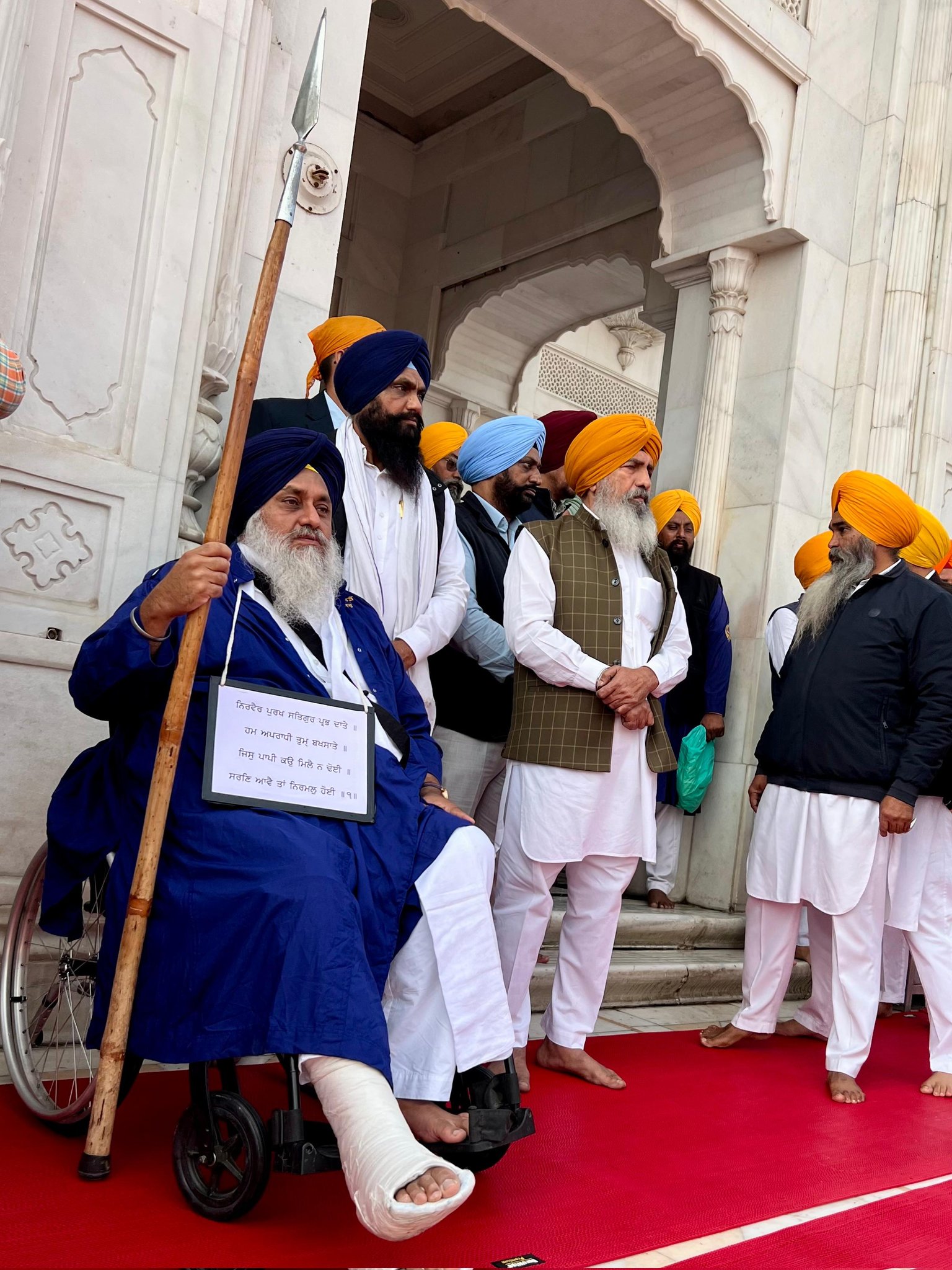 sukhbir singh badal sitting outside the golden temple.