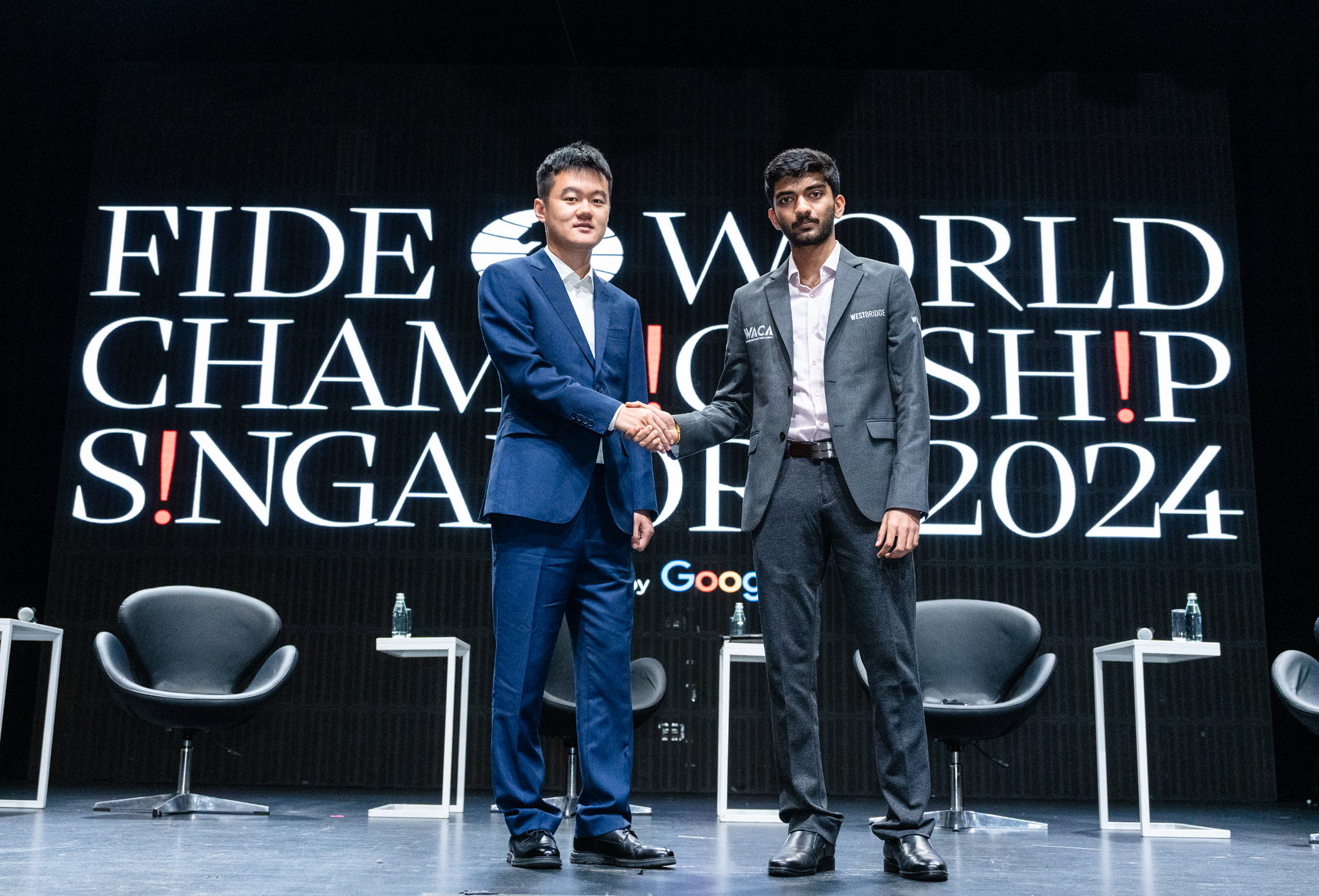 D Gukesh vs Ding Liren shaking hands in world chess championship 2024.