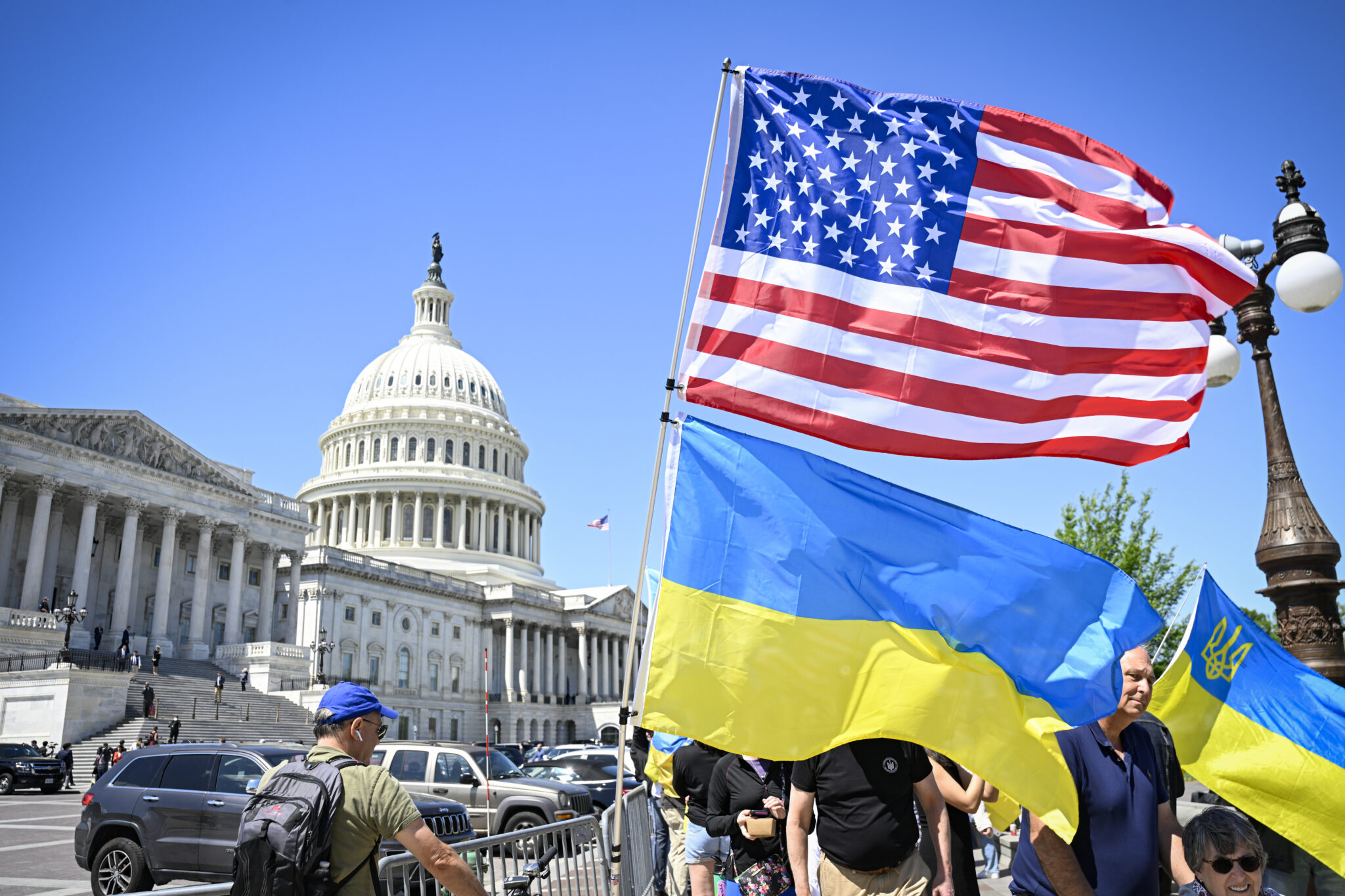 ukraine and usa flags waving in front of white house.