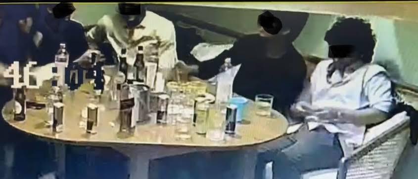 accused drinking with his friends in a bar