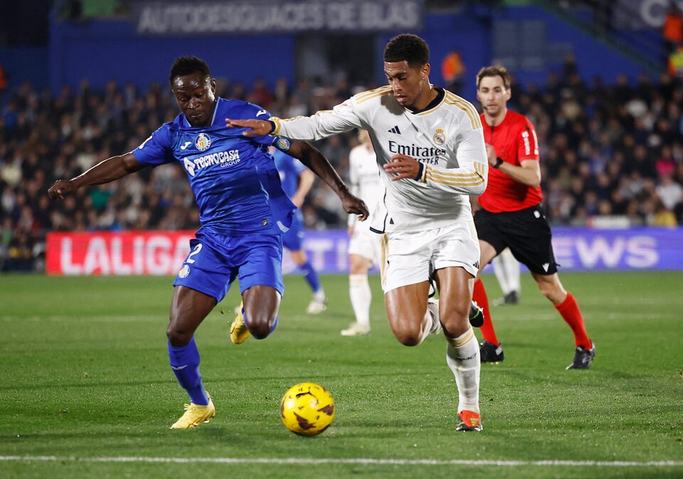  Getafe's Djene in action with Real Madrid's Jude Bellingham.