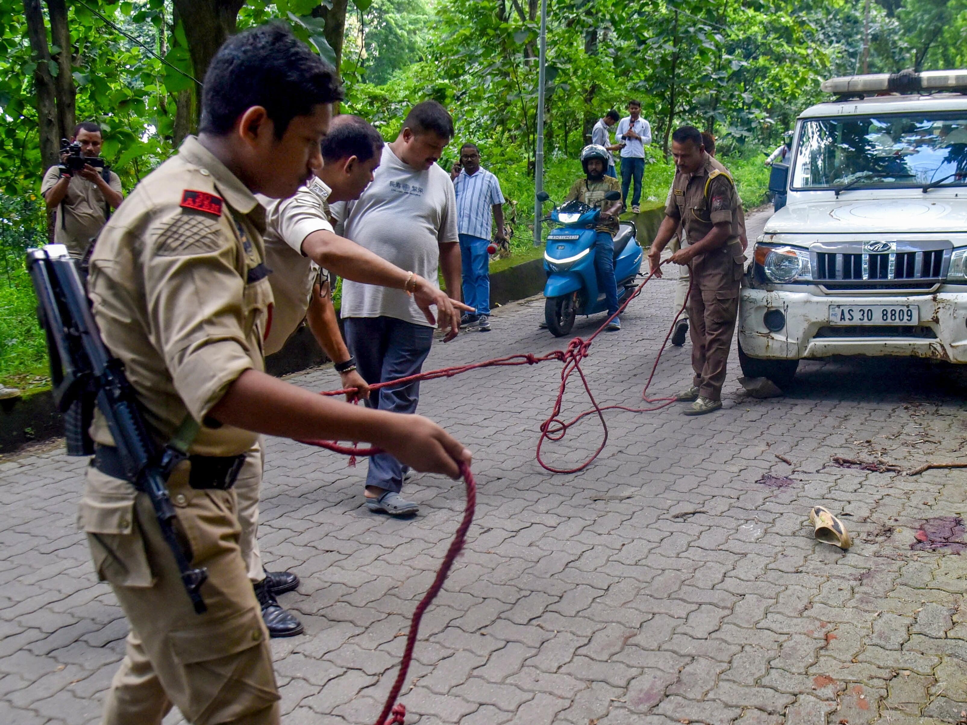 Police investigate the deadly shooting at Hotel Bilas Inn in Guwahati, Assam, where four people were killed.