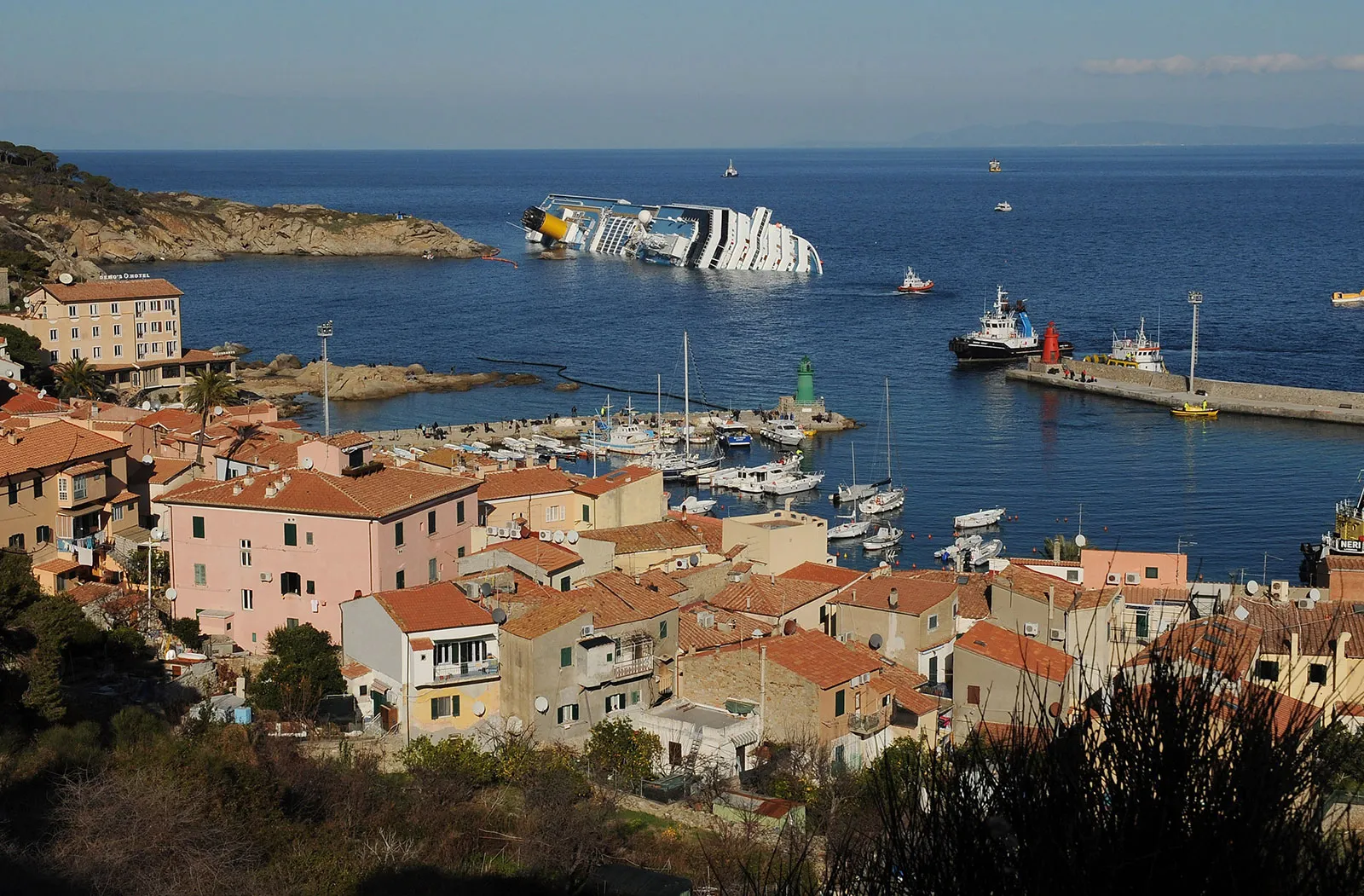 ruise ship Costa Concordia lying on its side after running aground off Giglio Island, Italy, 2012.