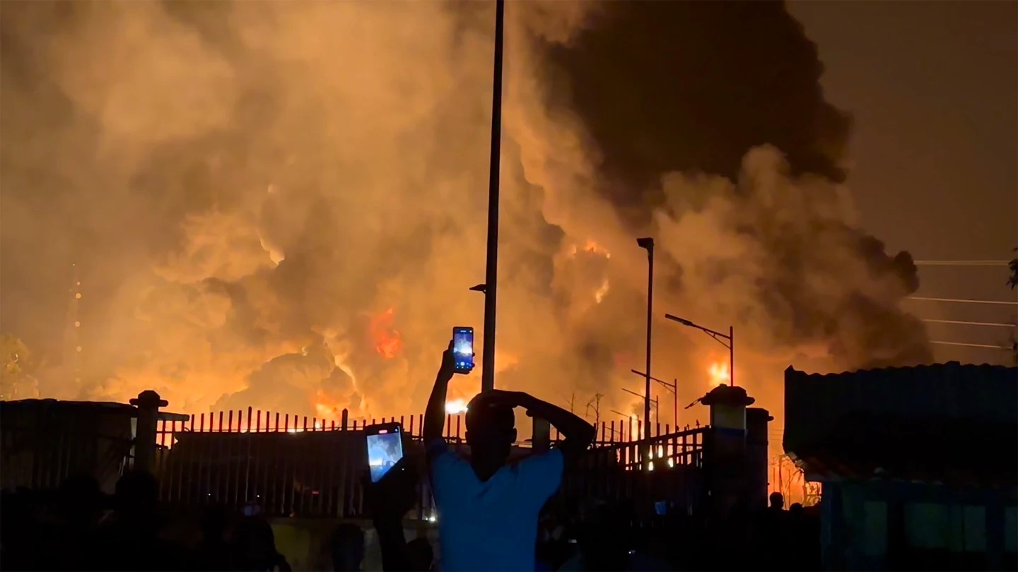 residents watching the depot burn - Conakry, Guinea