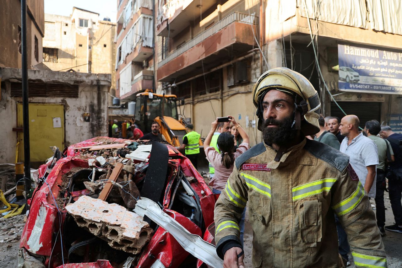 A firefighter works at the site of an Israeli strike, in Beirut's southern suburbs, Lebanon,